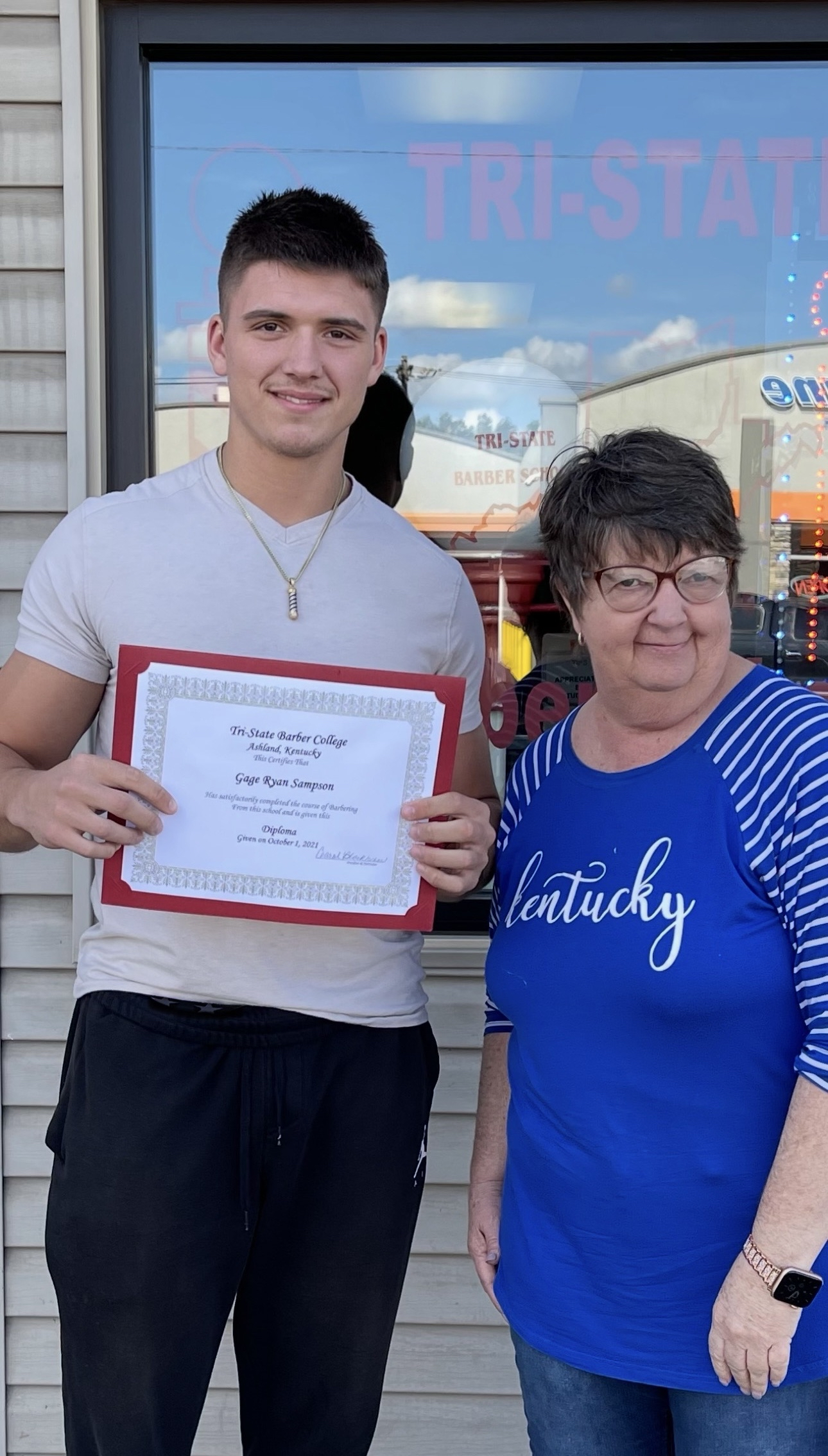Gage Sampson graduating barber school