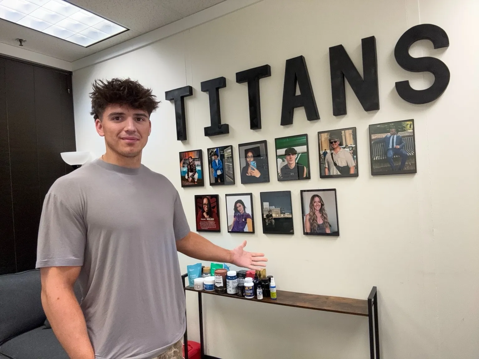 Gage Sampson at TikTok Titans headquarters with creator wall and brand products