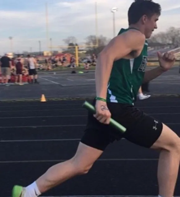 Gage Sampson running a track relay for the Green Bobcats in Franklin Furnace, Ohio